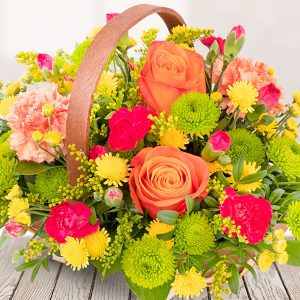 Wooden basket of mixed flowers